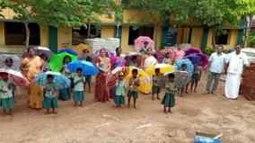 old-student-gifts-school-children-with-umbrellas