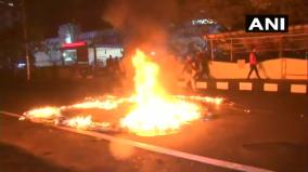 bus-torched-by-protesters-dispur