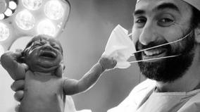 viral-pic-of-baby-removing-doctor-s-mask-becomes-symbol-of-hope