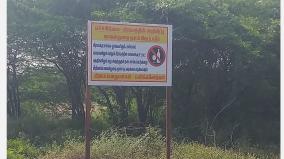 villagers-with-notice-boards-warning-drinkers