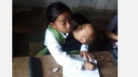 10-yr-old-girl-from-manipur-attends-class-while-babysitting-sister