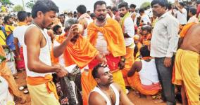 devotees-worship-by-breaking-the-coconut-on-the-head