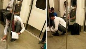 a-young-man-cleans-up-spilled-food-in-a-metro-train-with-a-handkerchief