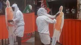 amit-shah-shares-video-of-old-man-cleaning-cut-out-of-pm-modi-soaked-in-rain