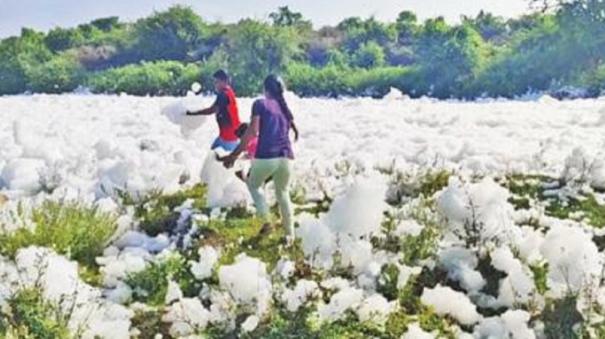 Children Playing on the Foam of the Hosur Kelavarapalli Dam Water