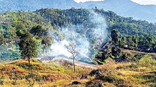 Elephant dung smoke and chili powder pose to ward off elephants in Pandalur