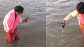 woman-dunks-phone-into-ganga-for-husband-virtual-maha-kumbh-dip