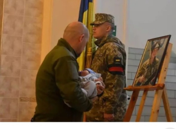 ukrainian-pilot-killed-in-battle-2-month-old-baby-pays-homage-to-fathers-picture