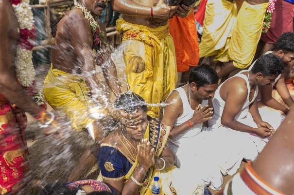 priest-breaks-coconuts-on-heads-of-karur-temple-devotees