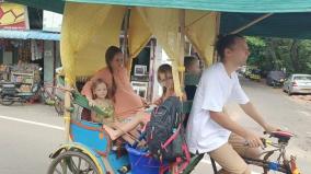 Russian Family Traveling on Traditional Roofed Rickshaw on Puducherry