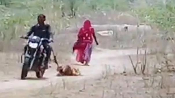 husband-drags-wife-behind-two-wheeler-shocking-video